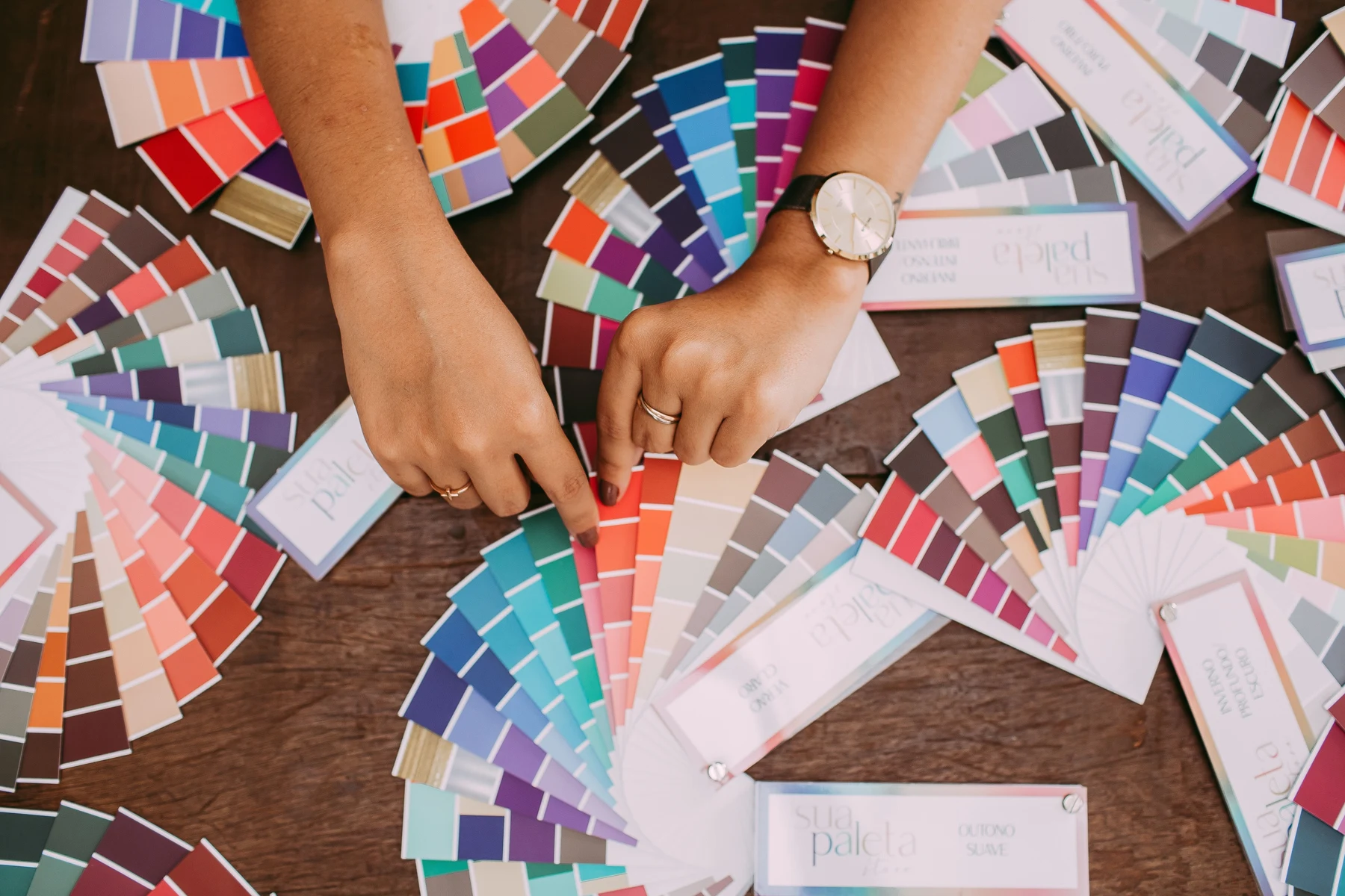 Hands comparing fabric and colour samples — representative stock photograph